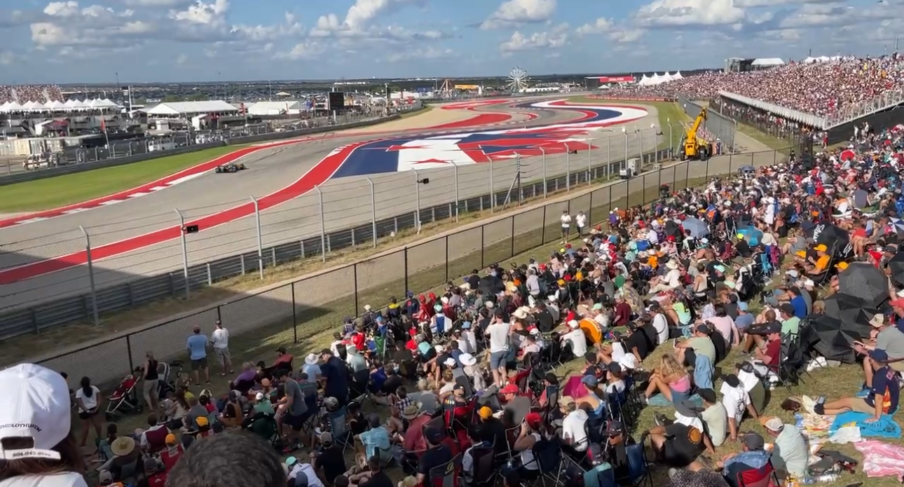 Formula 1 Grand Prix racing circuit with crowds of spectators showcasing premium sports travel experiences