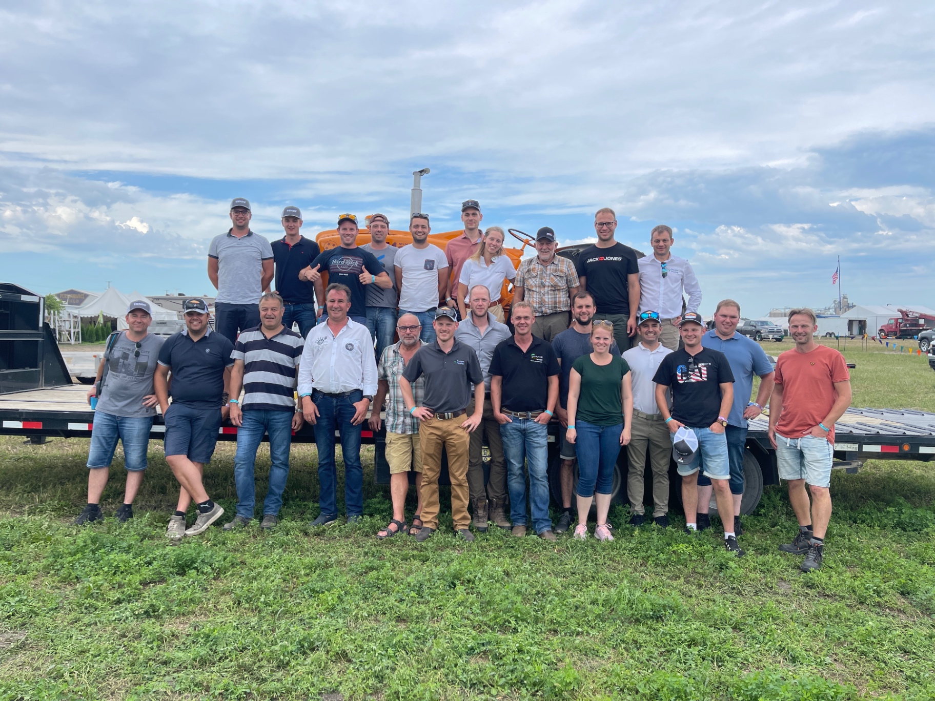 International agricultural tour group visiting American farm facility with modern equipment and expert guides